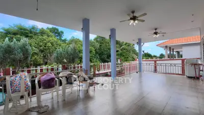 Spacious balcony with ceiling fans and garden view, perfect for relaxation and outdoor gatherings.
