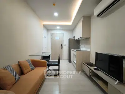 Modern living room with open kitchen layout and cozy sofa