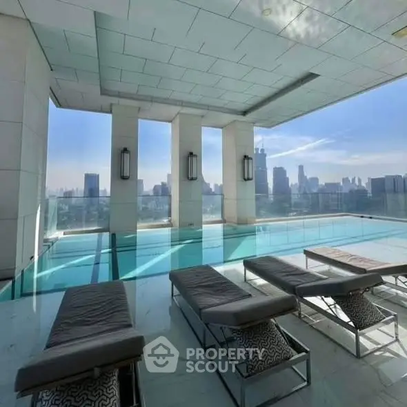 Luxurious rooftop pool with stunning city skyline views and modern lounge chairs.