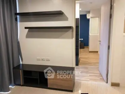 Modern apartment interior with sleek shelving and wooden flooring