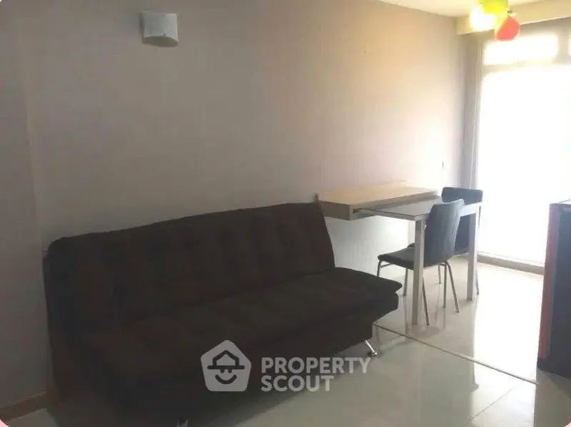 Cozy living room with modern sofa and dining area in bright apartment