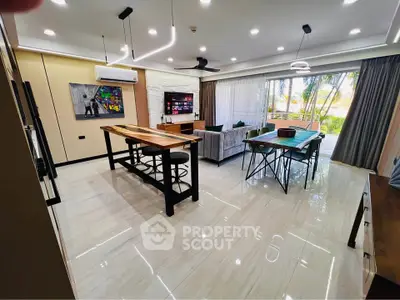 Spacious modern living room with stylish decor and large windows opening to a lush garden view.