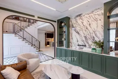 Luxurious living room with elegant marble accents and stylish green cabinetry
