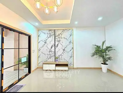 Modern living room with marble accent wall and elegant lighting