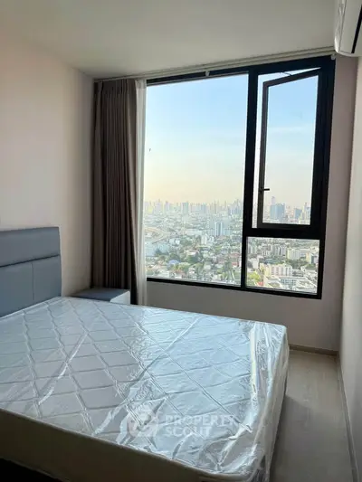 Modern bedroom with stunning city view from large window, featuring a comfortable bed and sleek design.