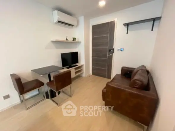 Modern living room with brown leather sofa and wall-mounted TV