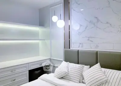 Modern bedroom with elegant marble accent wall and cozy lighting
