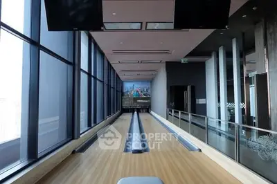 Luxurious high-rise building with indoor bowling alley and panoramic city views.