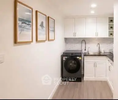 Modern laundry room with sleek design and washer in a compact space.