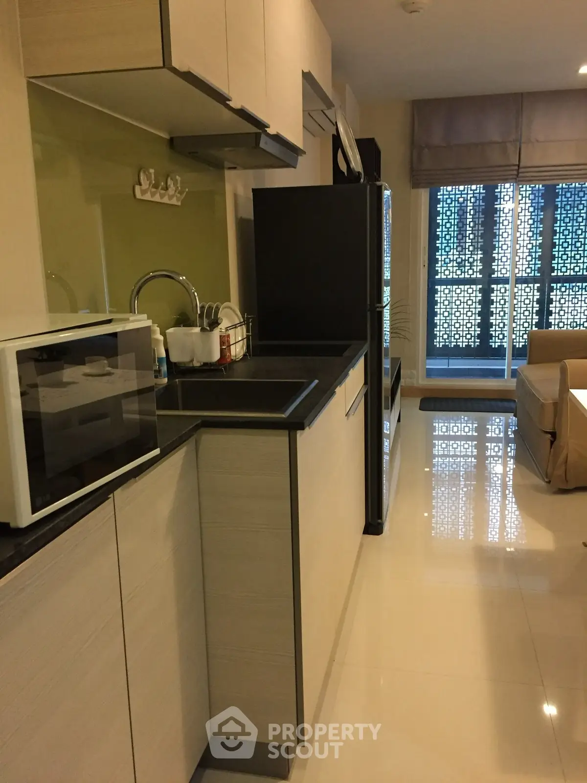 Modern kitchen with sleek cabinetry and appliances in a stylish apartment.