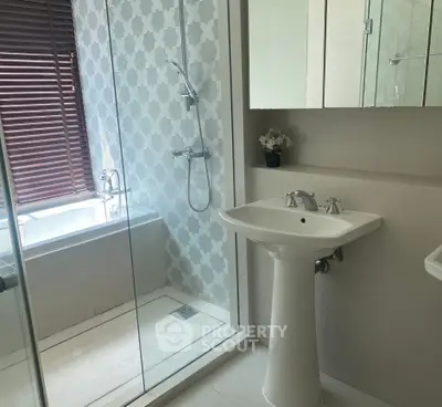 Modern bathroom with glass shower and stylish tile design