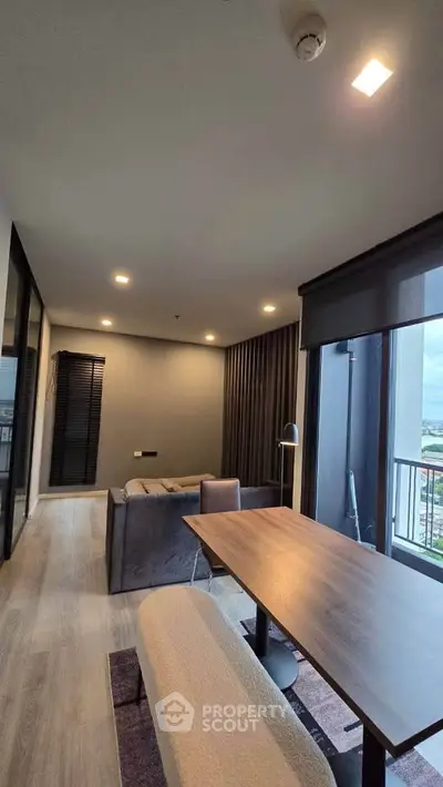 Modern living room with stylish furniture and large windows offering a stunning view.