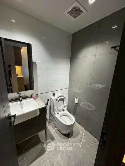 Modern bathroom with sleek design and contemporary fixtures in a stylish apartment.