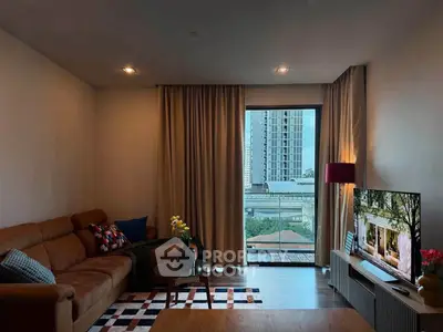 Stylish living room with modern decor and city view, featuring a cozy leather sofa and large window.