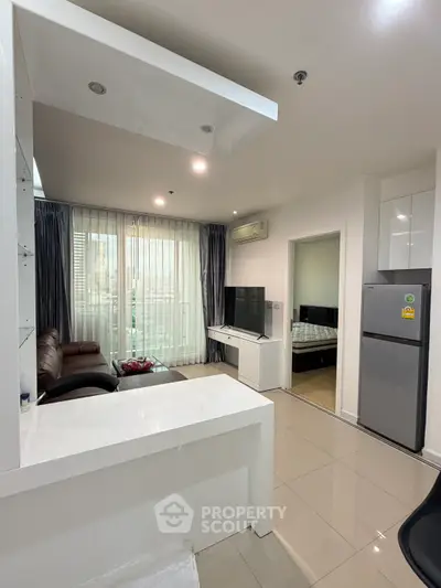 Modern open-layout living room with sleek kitchen and balcony view