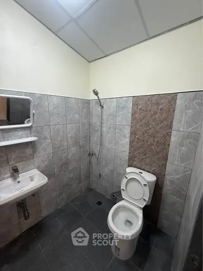 Modern bathroom with sleek tile design and contemporary fixtures.