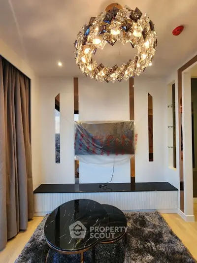 Luxurious living room with modern chandelier and stylish furniture