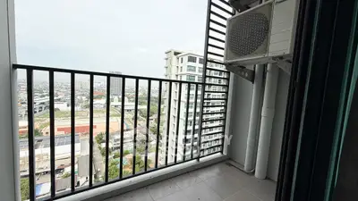 City view from a high-rise balcony with air conditioning unit