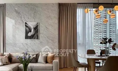 Elegant living room with modern decor and city view, featuring stylish lighting and marble accent wall.