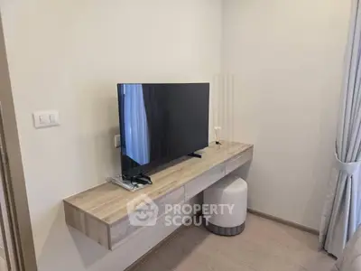 Modern minimalist living room with wall-mounted TV and sleek furniture