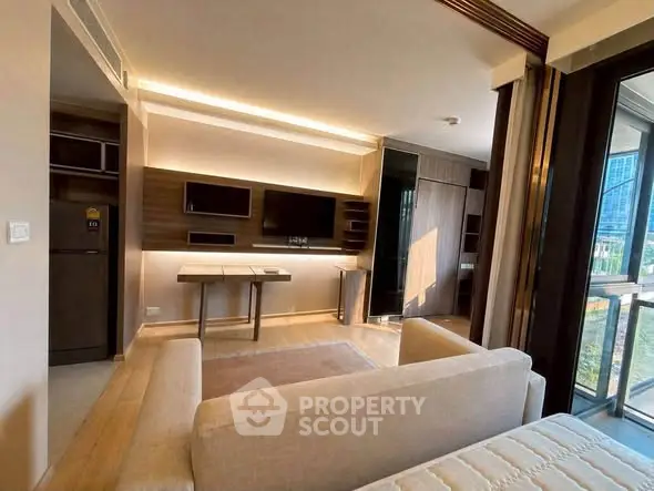 Modern living room with sleek design and large windows offering natural light and city views.