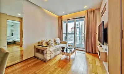 Modern living room with hardwood floors and city view balcony