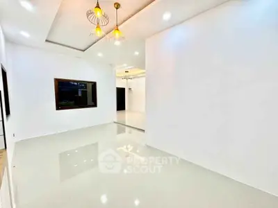 Spacious modern living room with elegant lighting and glossy flooring