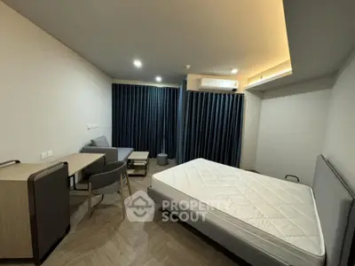 Modern bedroom with minimalist furniture and large window for natural light