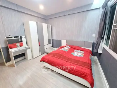 Modern bedroom with stylish decor and ample storage in a cozy apartment.