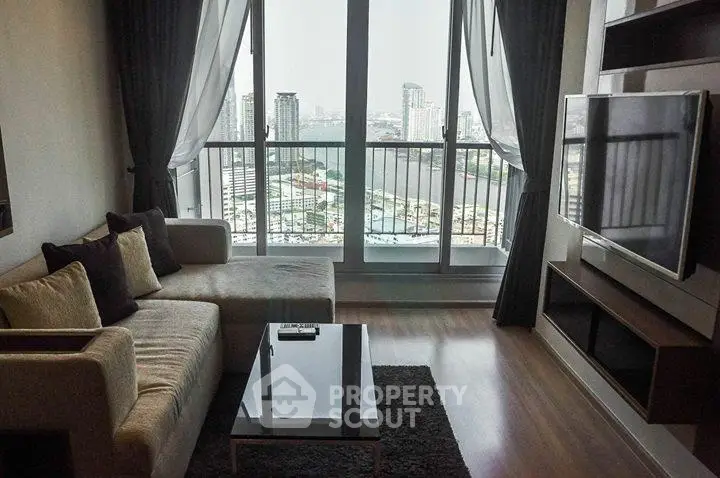 Modern living room with city view, large windows, and sleek furniture in a high-rise apartment.