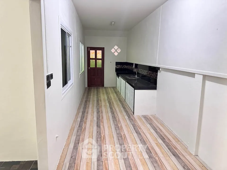 Spacious kitchen with sleek countertops and modern flooring, perfect for culinary enthusiasts.