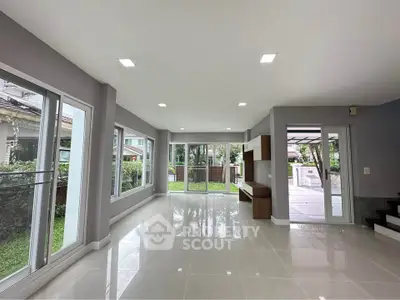 Spacious modern living room with large windows and garden view