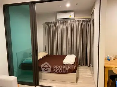 Cozy bedroom with modern design and air conditioning, featuring a comfortable bed and stylish curtains.