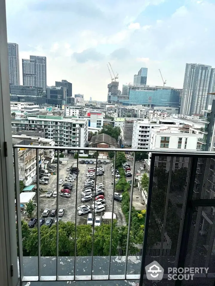 Stunning cityscape view from a high-rise balcony overlooking urban skyline and construction sites.