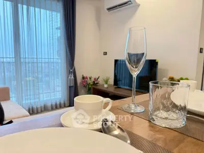 Modern living room with elegant dining setup and large window view.