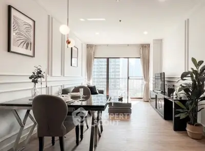 Stylish modern living room with dining area and city view balcony in luxury apartment.