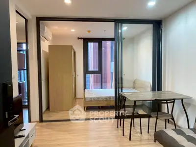 Modern studio apartment with glass partition and cozy dining area