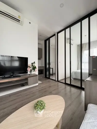 Modern living room with sleek glass partition and stylish decor