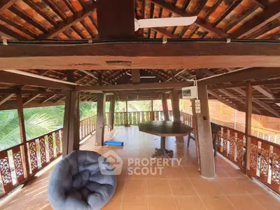 Charming rustic balcony with wooden beams and cozy seating, perfect for relaxation.