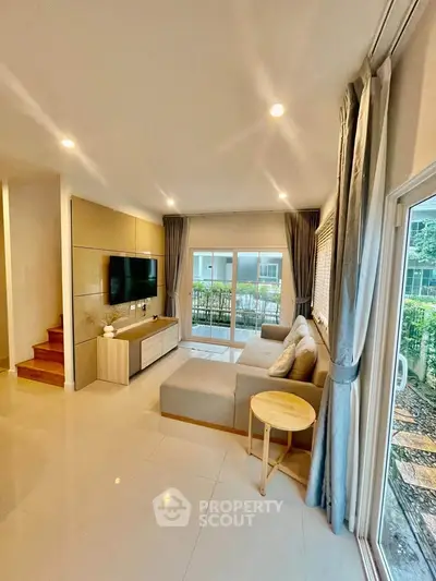 Modern living room with large windows and cozy sectional sofa