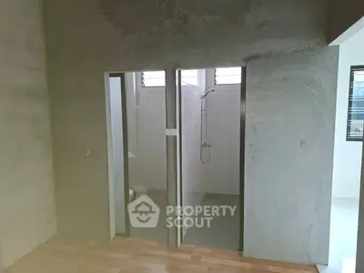 Minimalist unfinished bathroom with concrete walls and tiled shower area