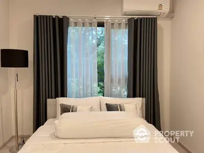 Cozy bedroom with elegant curtains and modern air conditioning unit