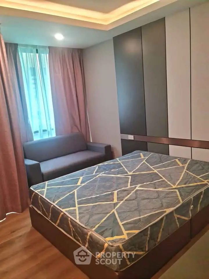 Modern bedroom with stylish decor and cozy seating area