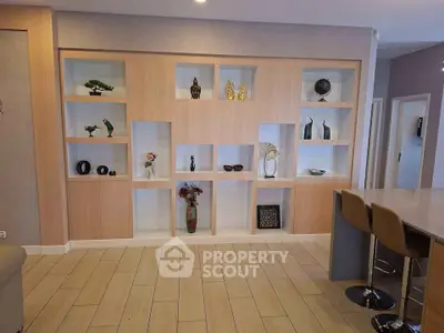 Modern living room with stylish built-in shelving and elegant decor accents