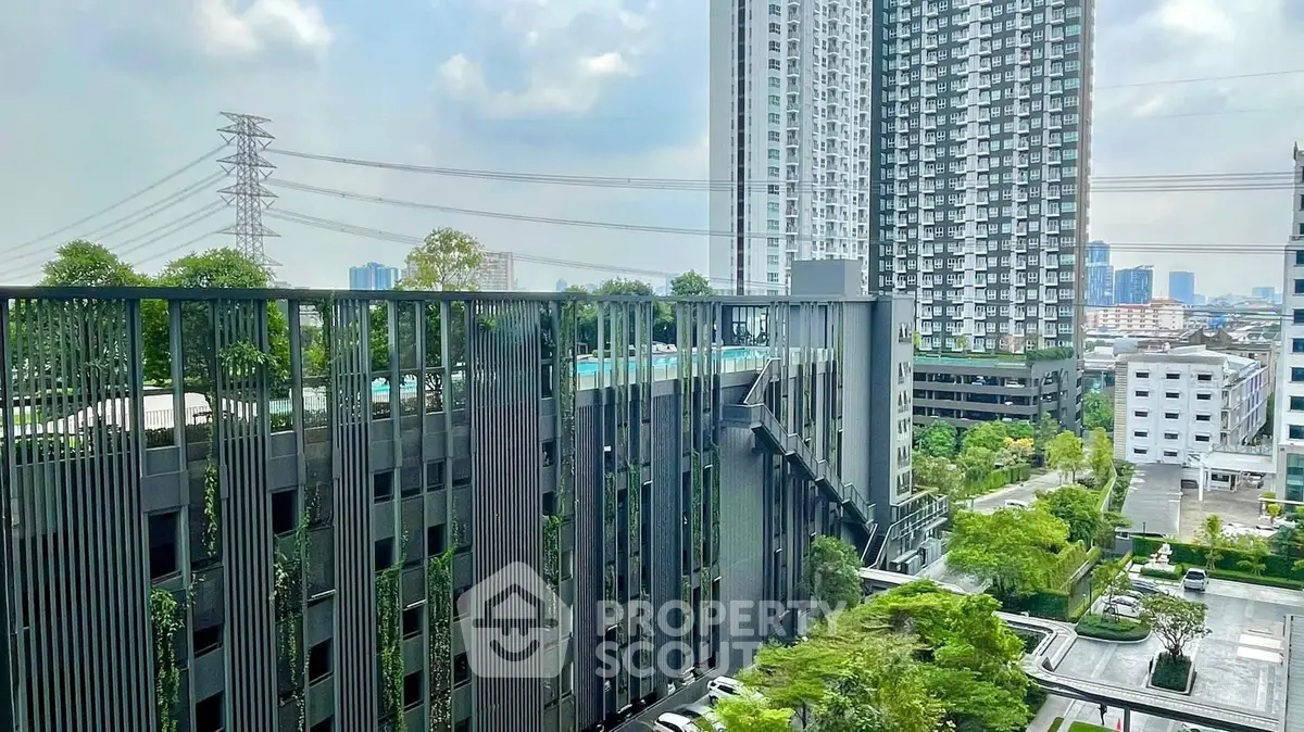 Stunning urban high-rise view with lush greenery and modern architecture.