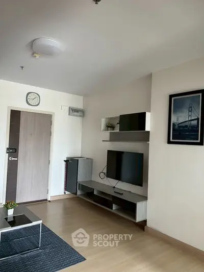 Modern living room with sleek TV unit and stylish decor in a contemporary apartment.