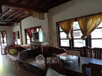 Charming rustic living room with wooden furniture and vintage TV, perfect for cozy gatherings.