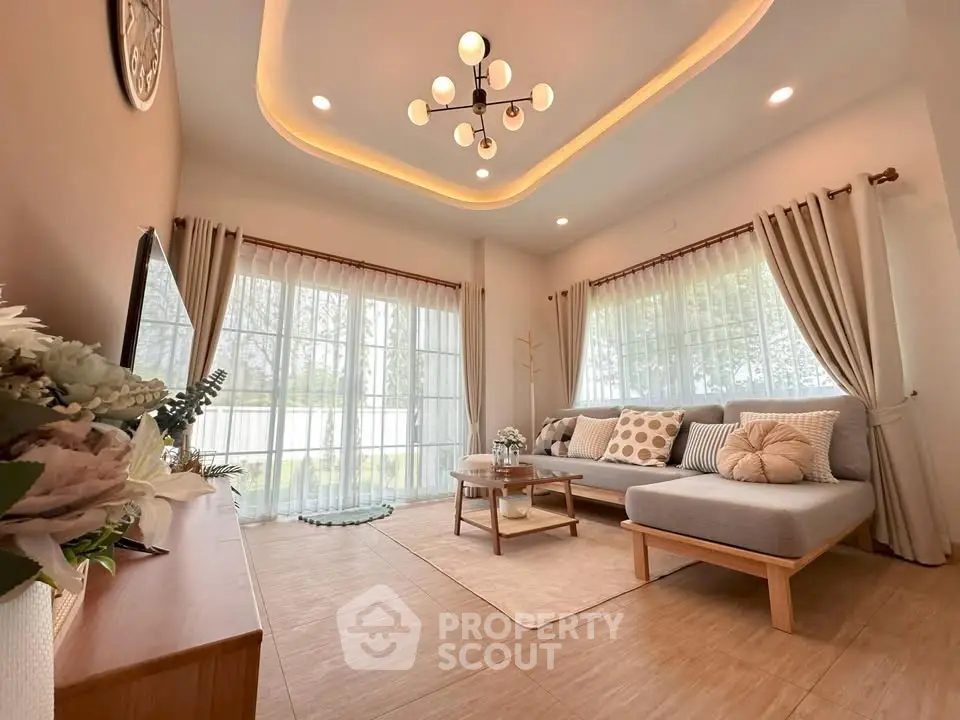 Elegant living room with modern decor and large windows offering serene views.