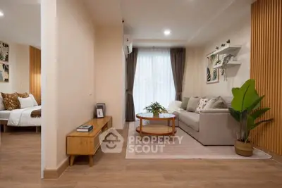 Modern living room with cozy sofa, wooden accents, and natural light in stylish apartment.