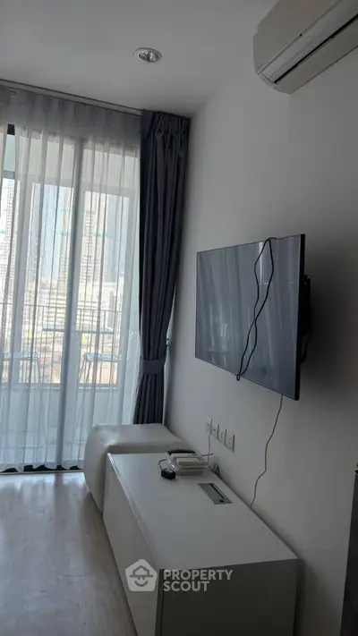 Modern living room with wall-mounted TV and large window view